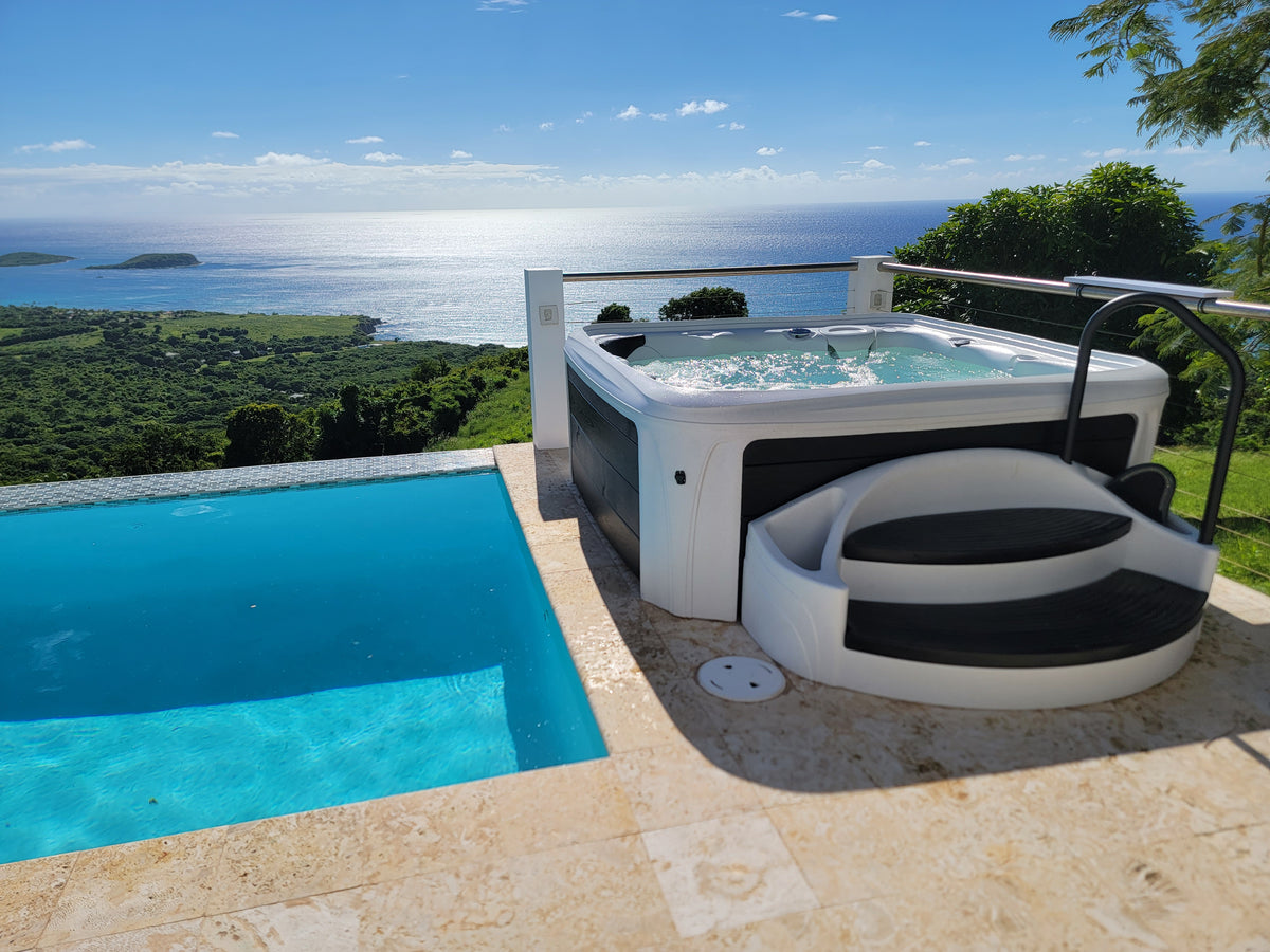 Dream Maker hot tub installed beside an outdoor pool and terrace